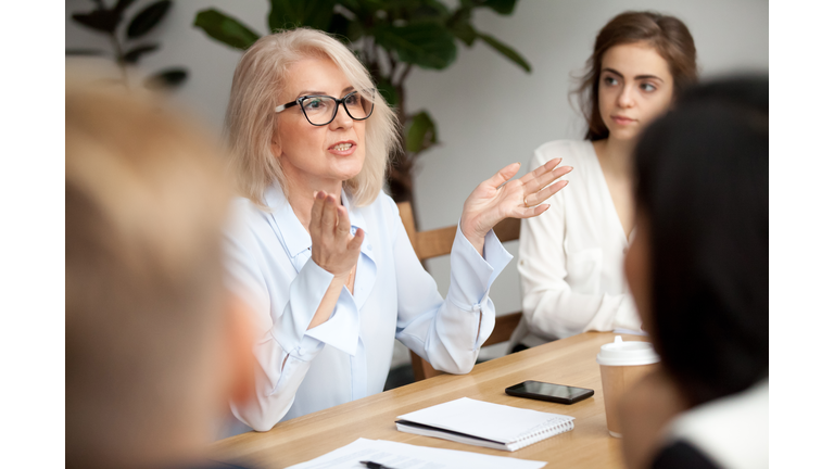 Businesswoman working with young people in a work setting.