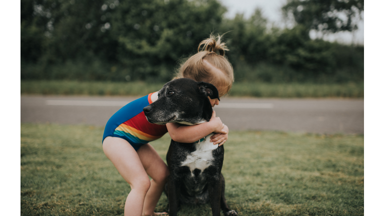 Girl hugs Dog