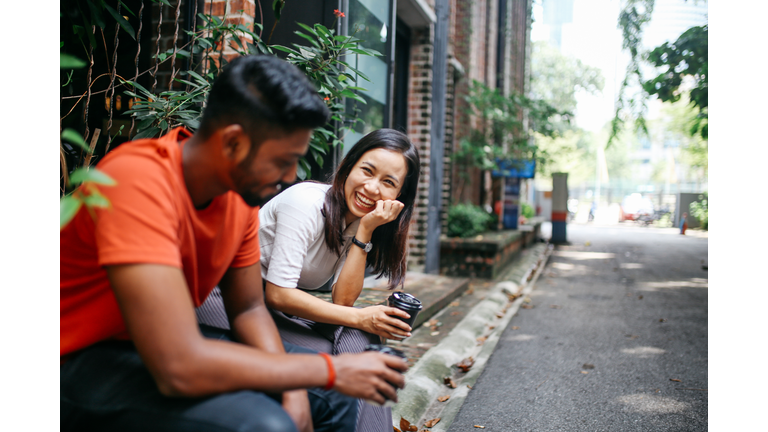 Friends chatting outdoors in Kuala Lumpur, Malaysia