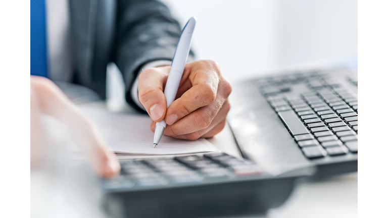 Business man using calculator