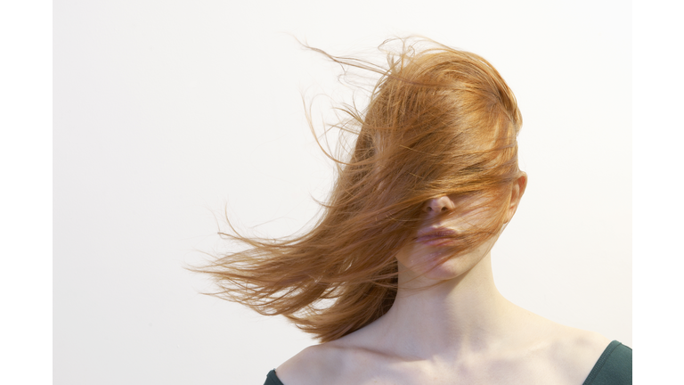 woman with hair blowing over face