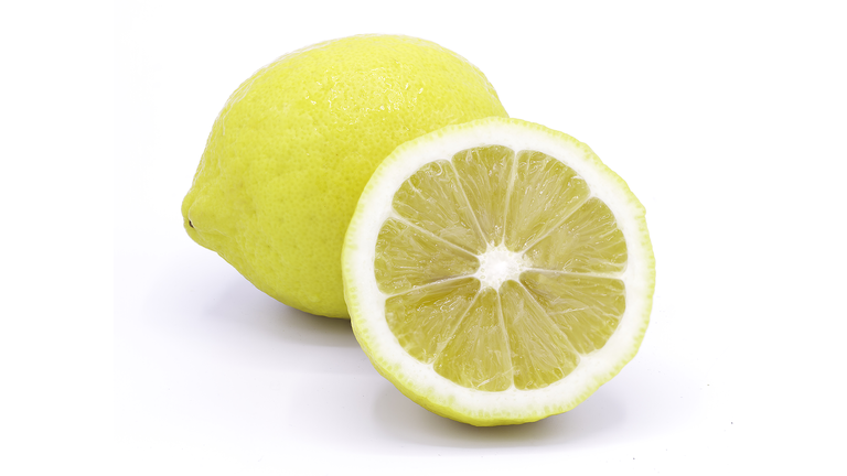 Close-Up Of Lemon Slice Against White Background