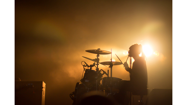 Drummer Performing On Stage During Concert