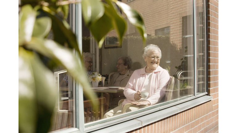 Elderly Women Sitting in Nursing Home Window