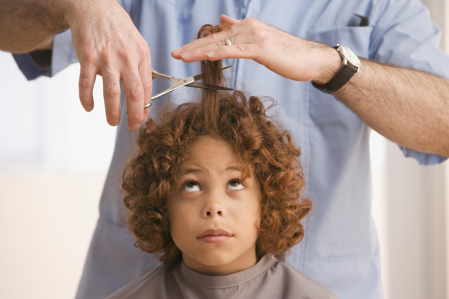 Mixed Race boy getting haircut