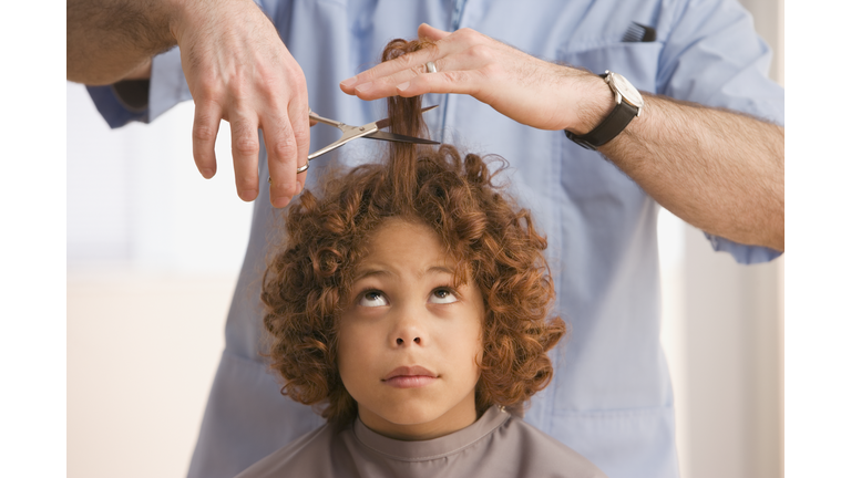 Mixed Race boy getting haircut