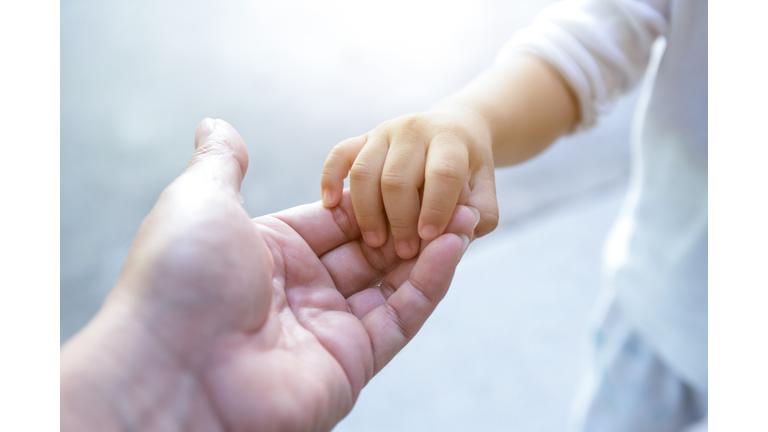 holding baby hand