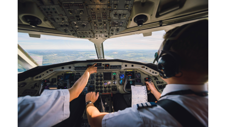 Pilots switching control in cockpit of commercial airplane