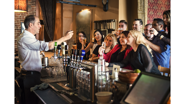 Friends and coworkers party in a bar.