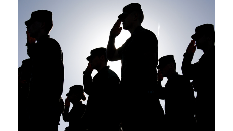 Soldiers Salute the Flag at Sunset