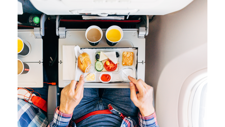 Eating airplane food during a flight, personal perspective directly above view