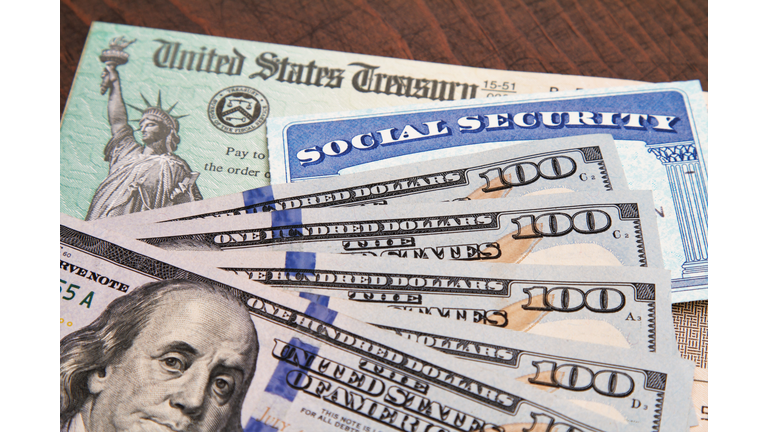 Money: closeup of USA currency with government treasury check and social security card