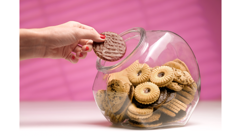 Woman stealing biscuit, caught in the act.