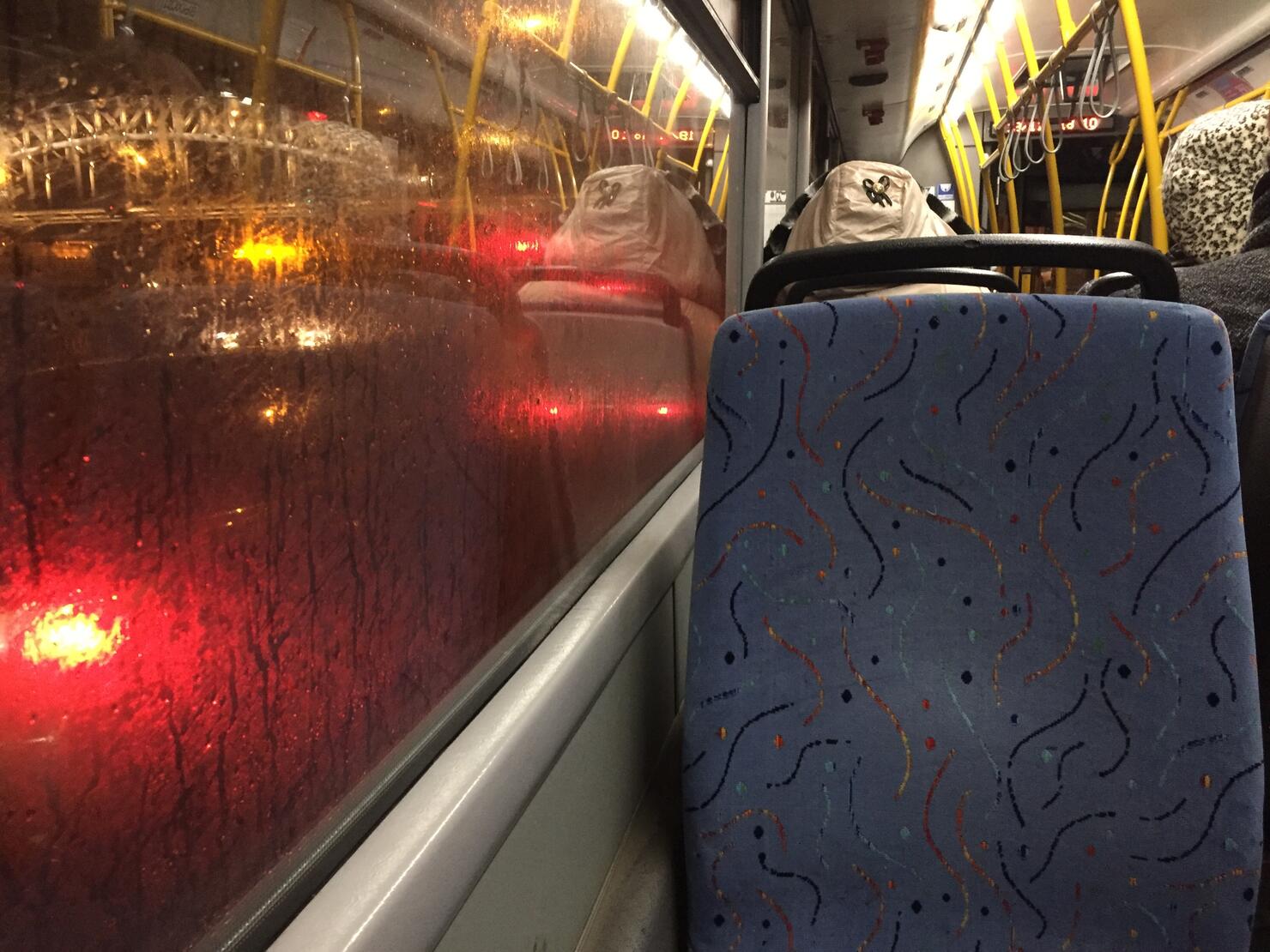 Taking city bus on a rainy evening