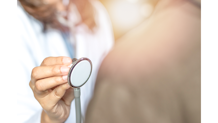 Medical doctor or physician in white gown uniform hand holding  stethoscope check up patient in hospital or clinic. Healthcare concept.