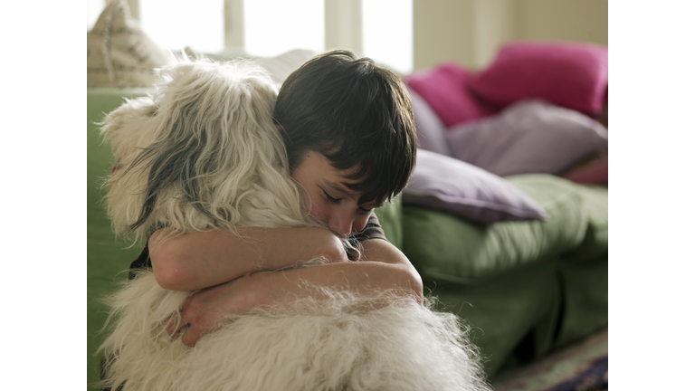 Boy hugging his dog