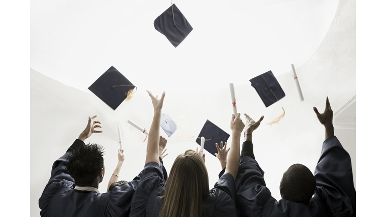 Graduates throwing mortarboards