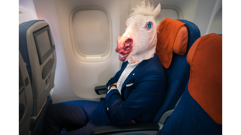 Strange passenger in elegant suit sits alone inside the aircraft and ready to take off