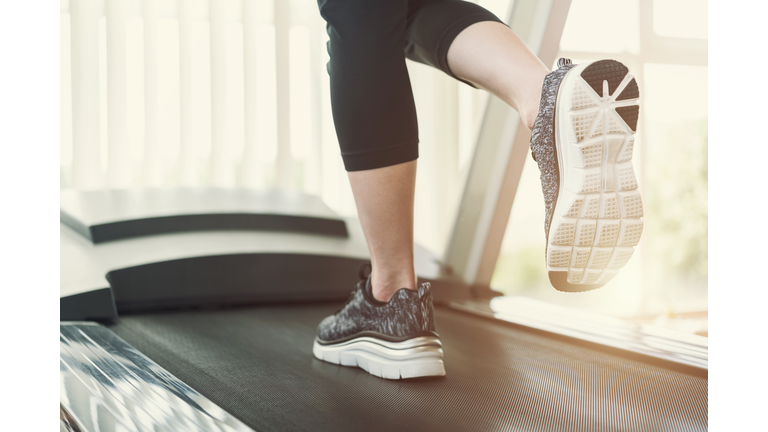 Low Section Of Woman Running On Treadmill