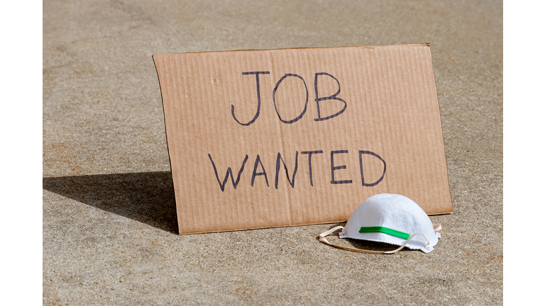 Job wanted cardboard sign and N95 respirator mask. Concept of recession, unemployment and layoffs due to Covid-19 coronavirus pandemic