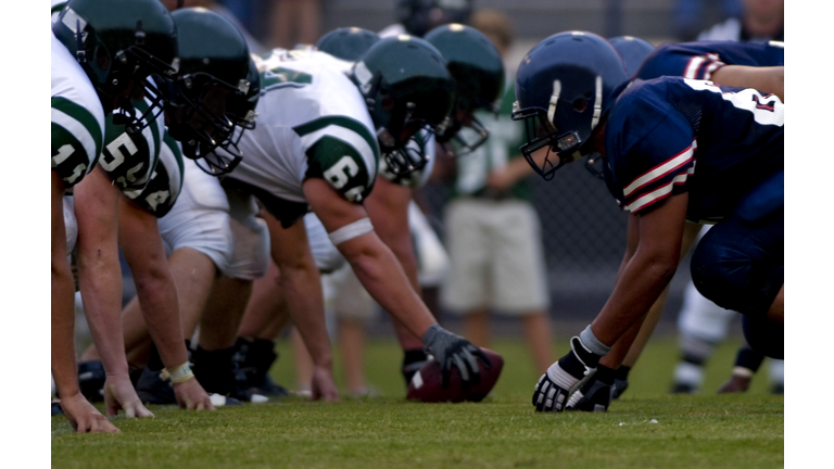 American Football Players at Line of Scrimmage during Football Game