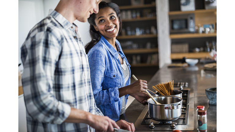 Couple cooking together in kitchen