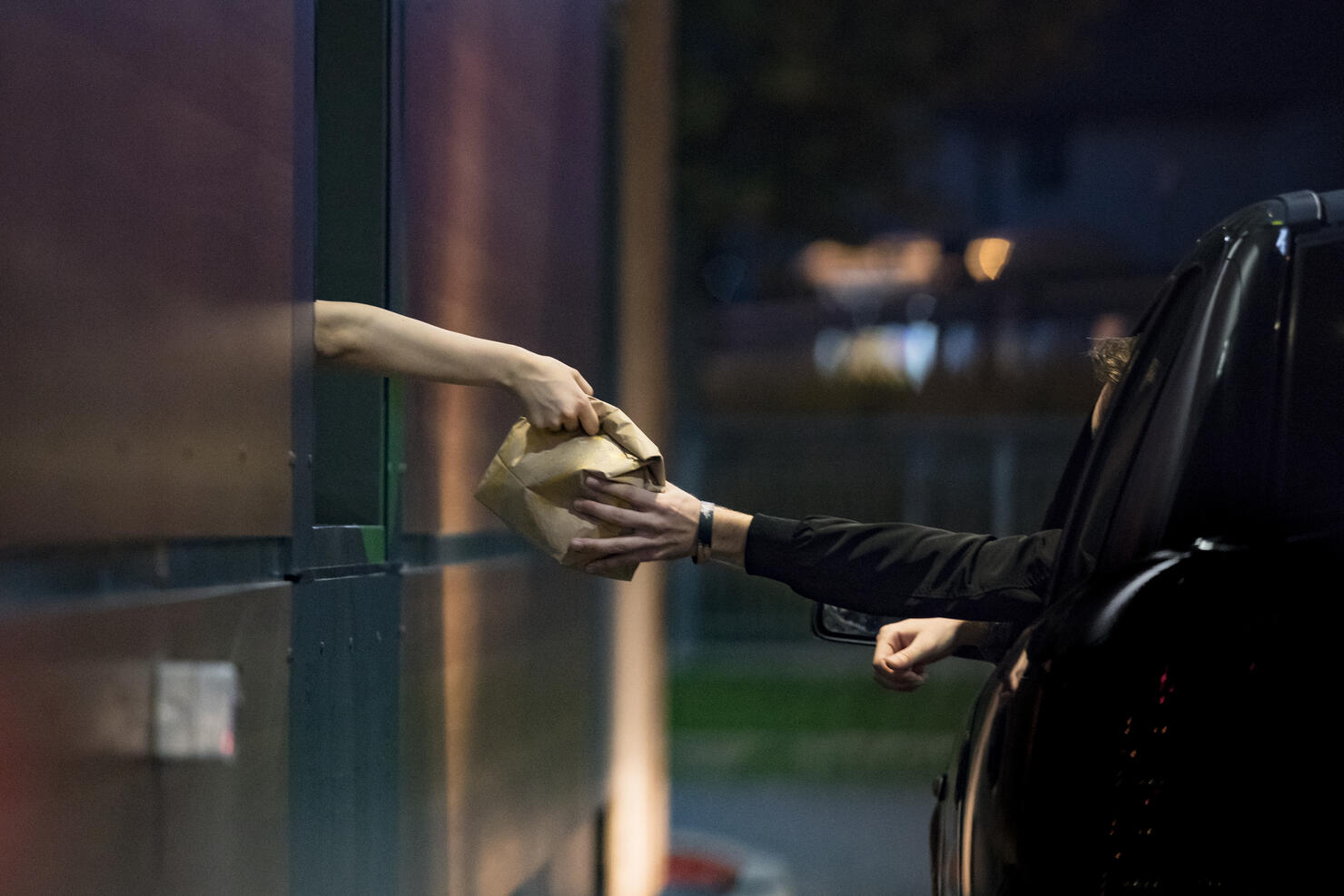 Customer Receiving Food at Drive Thru