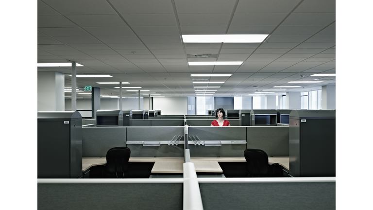 Businesswoman standing alone in empty office