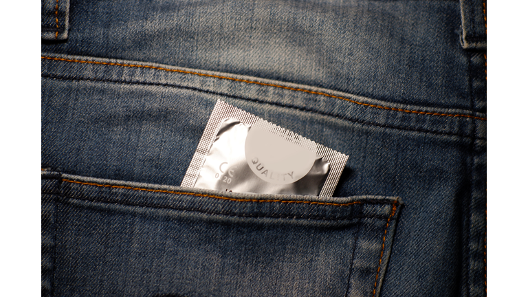 Close-Up Of Condom Packet In Jeans Pocket