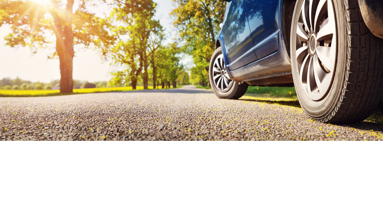 Car on asphalt road in summer