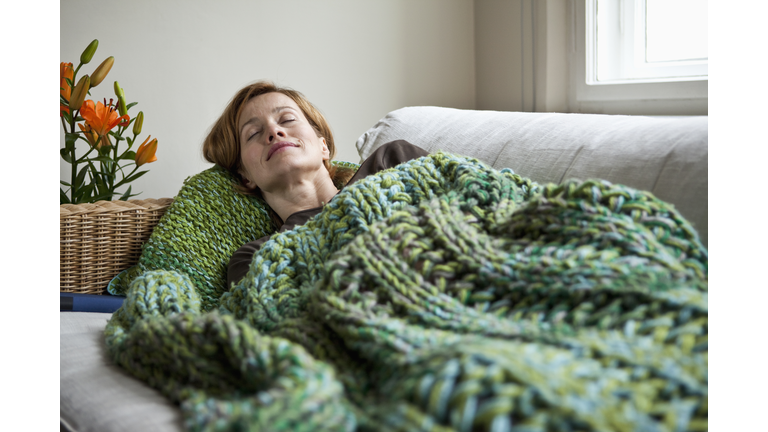 A woman napping on a sofa