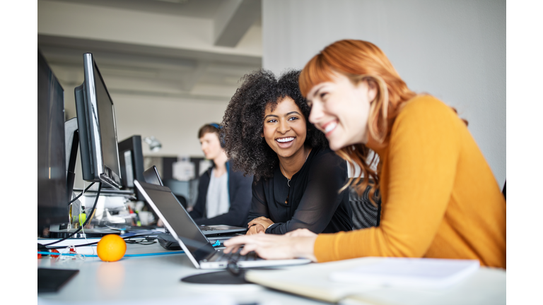 Two female colleagues in office working together