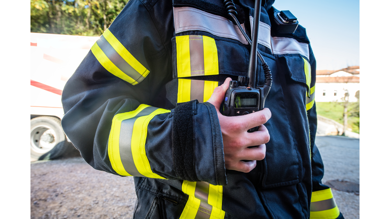 Firefighter using walkie talkie, rescue operation Close Up
