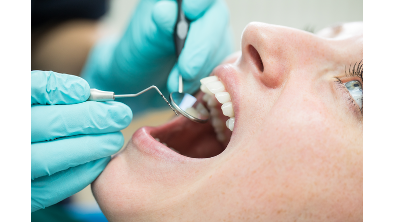 Woman getting a dental check-up at dentistry