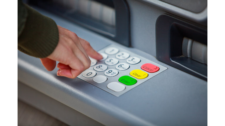 Cropped Hand Of Man Using Atm