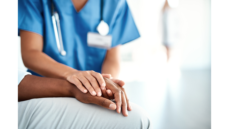 Nurse comforting patient in hospital