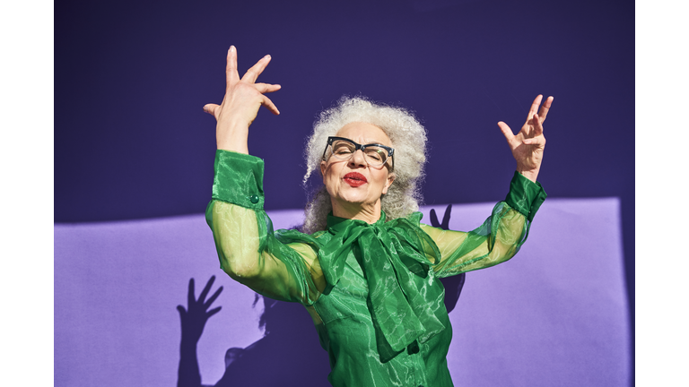 Colourful studio portrait of a senior woman