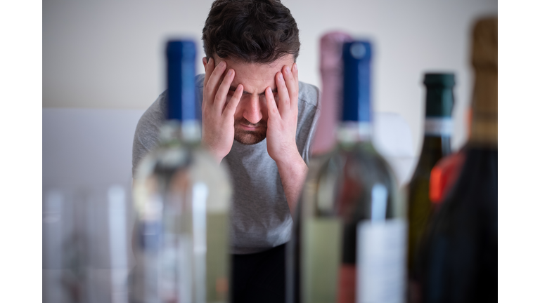 Depressed man drinking hard liquor at home