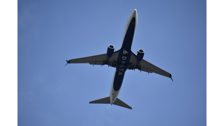 Delta Airline Aircraft Ascending into Blue Sky