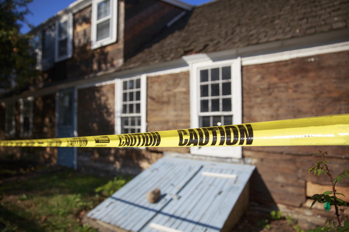 caution tape blocking the way into the building