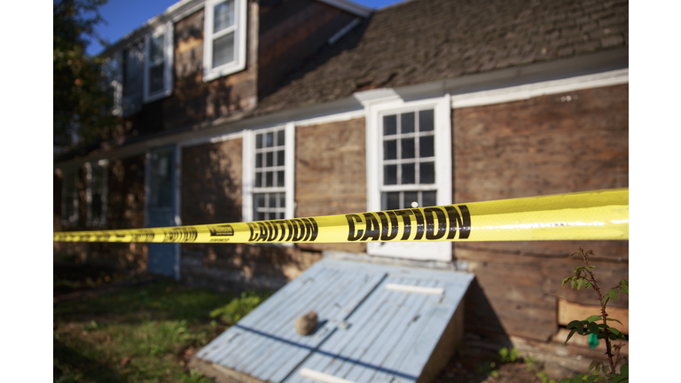 caution tape blocking the way into the building