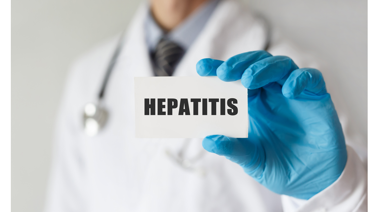 Doctor holding a card with text HEPATITIS, medical concept