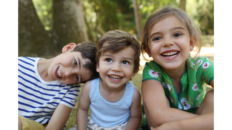 3 brothers and sister posing together in the garden