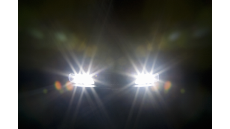 A car headlights illuminated at night