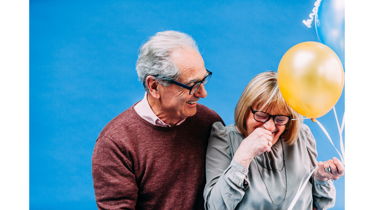 Happy Senior French Couple with Baloons