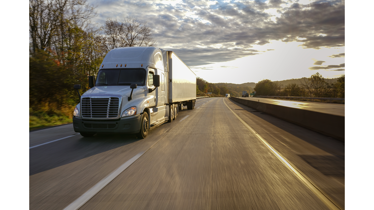 18 wheeler truck on road at sunrise