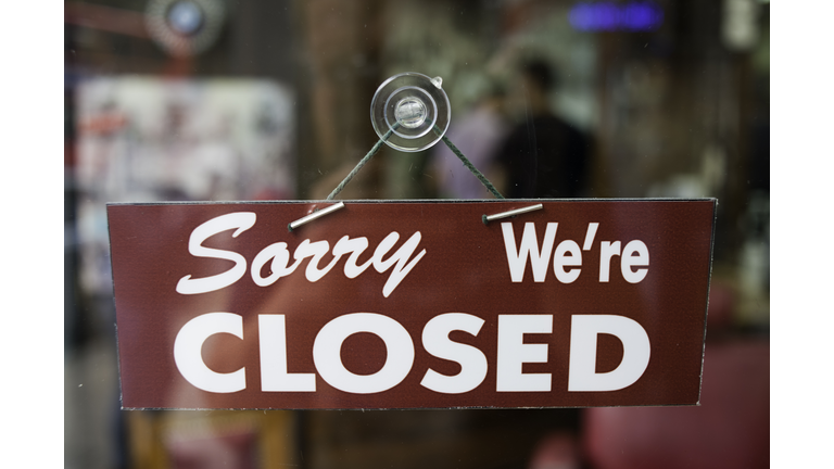 View through window of closed sign in shop