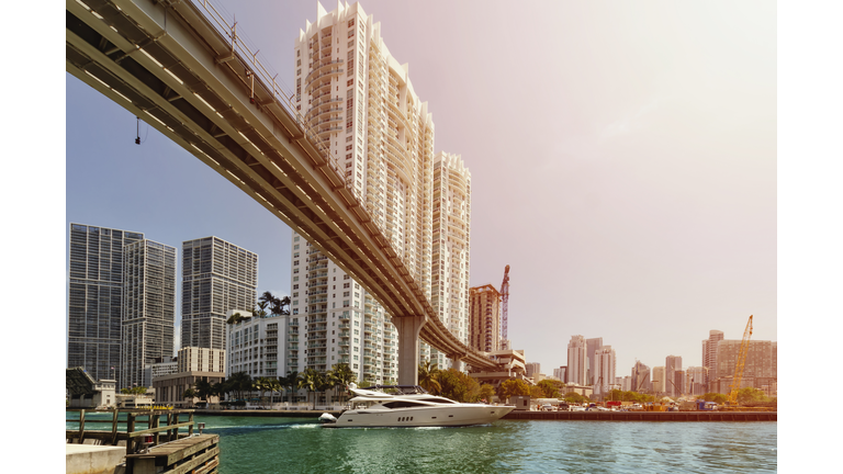 Boat passing under a bridge on Miami River.