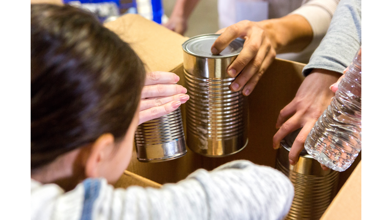 Little girl donates canned goods during food drive