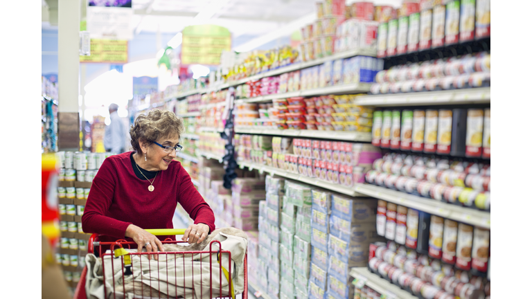 Senior Hispanic woman shopping in grocery store